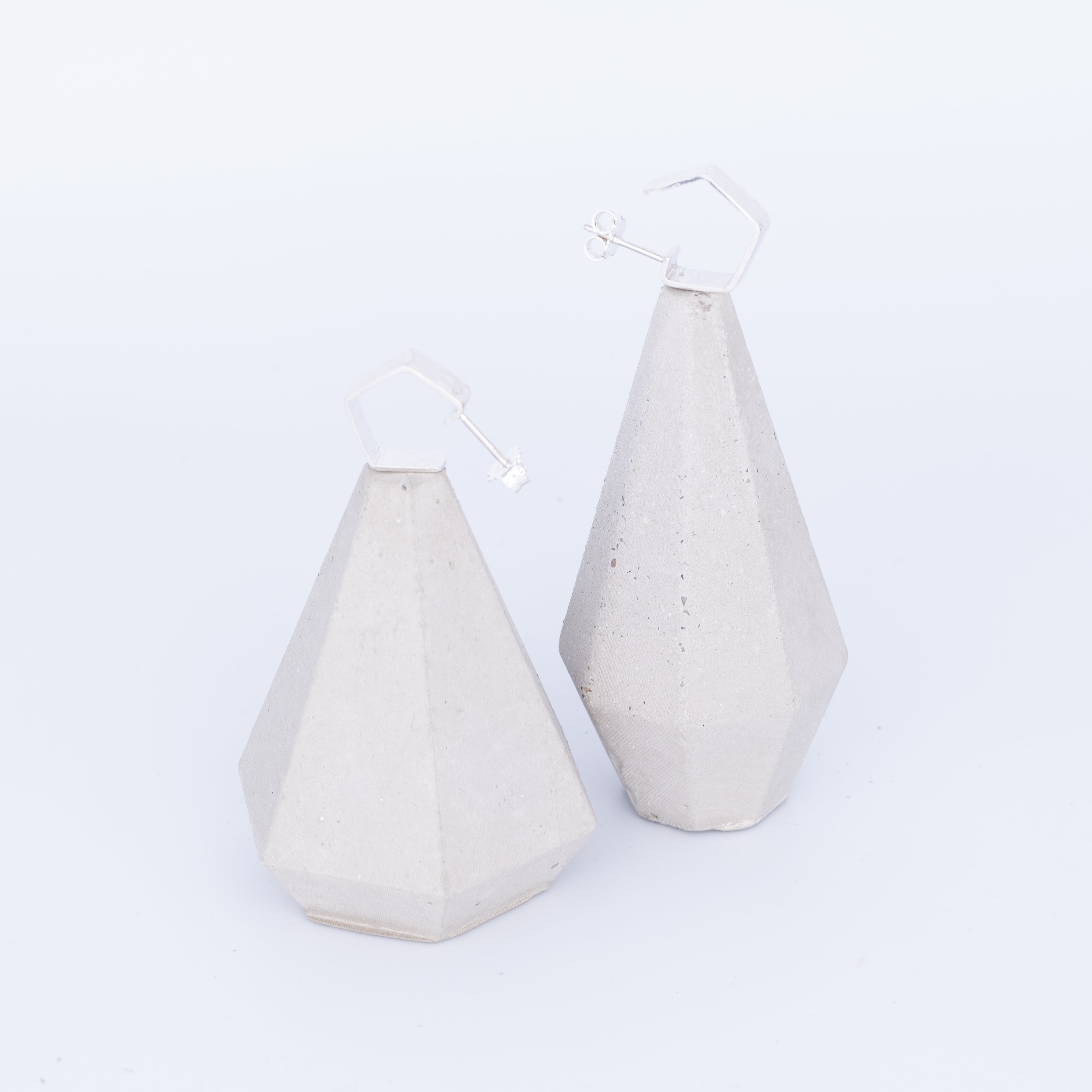 Two geometrically shaped ceramic vases on a white background