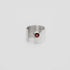 Silver ring with a red garnet gemstone on a light gray background