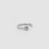 Silver ring with a blue gemstone on a light gray background