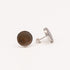 Pair of silver wing-shaped earrings on a light gray background with motzher of pearl 