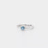 Silver ring with a blue gemstone on a white background