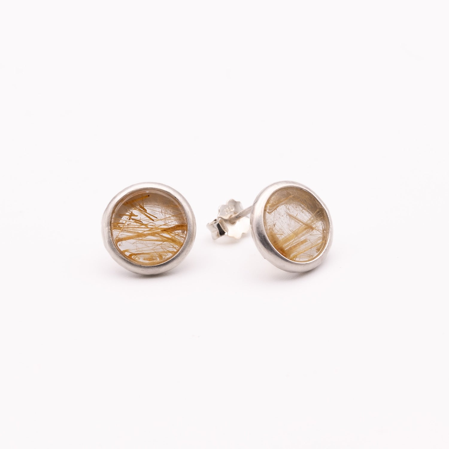 Pair of silver earrings with natural stone design on a white background