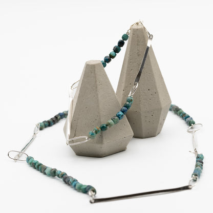 Necklace with blue beads on a white background