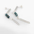 Silver earrings with blue beads on a white background