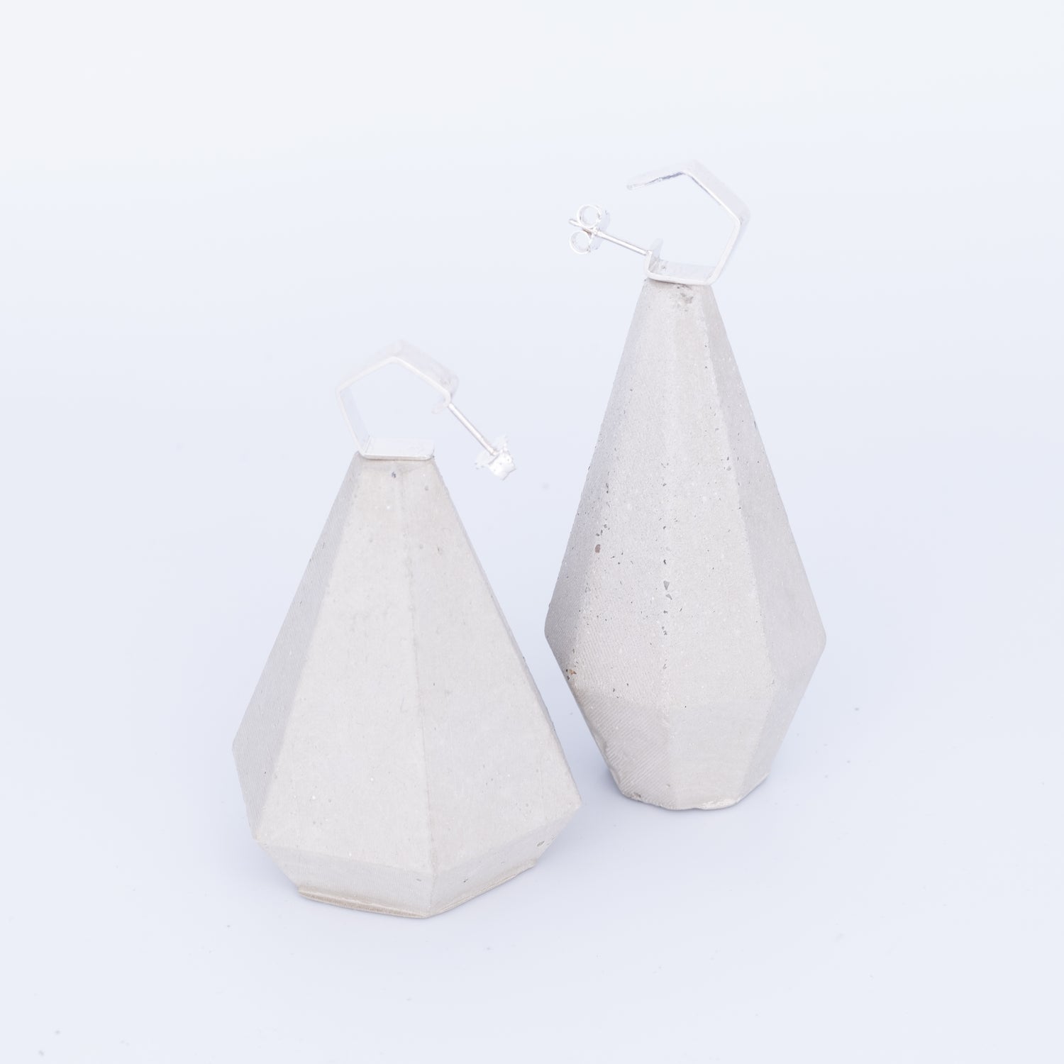 Two geometrically shaped ceramic vases on a white background