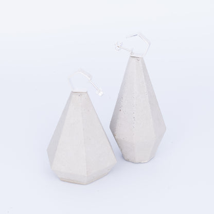 Two geometrically shaped ceramic vases on a white background