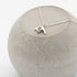 Silver necklace with a pendant on a concrete block