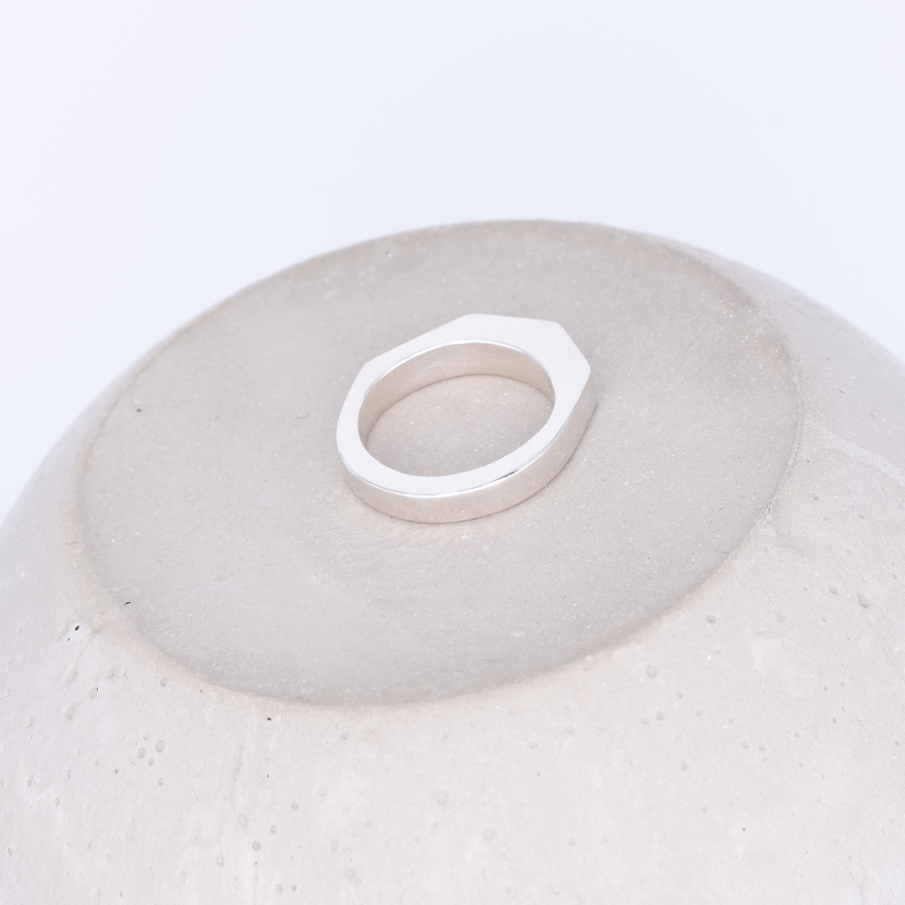 Silver ring on a textured white surface