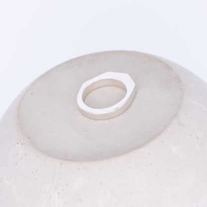 Silver ring on a textured white surface
