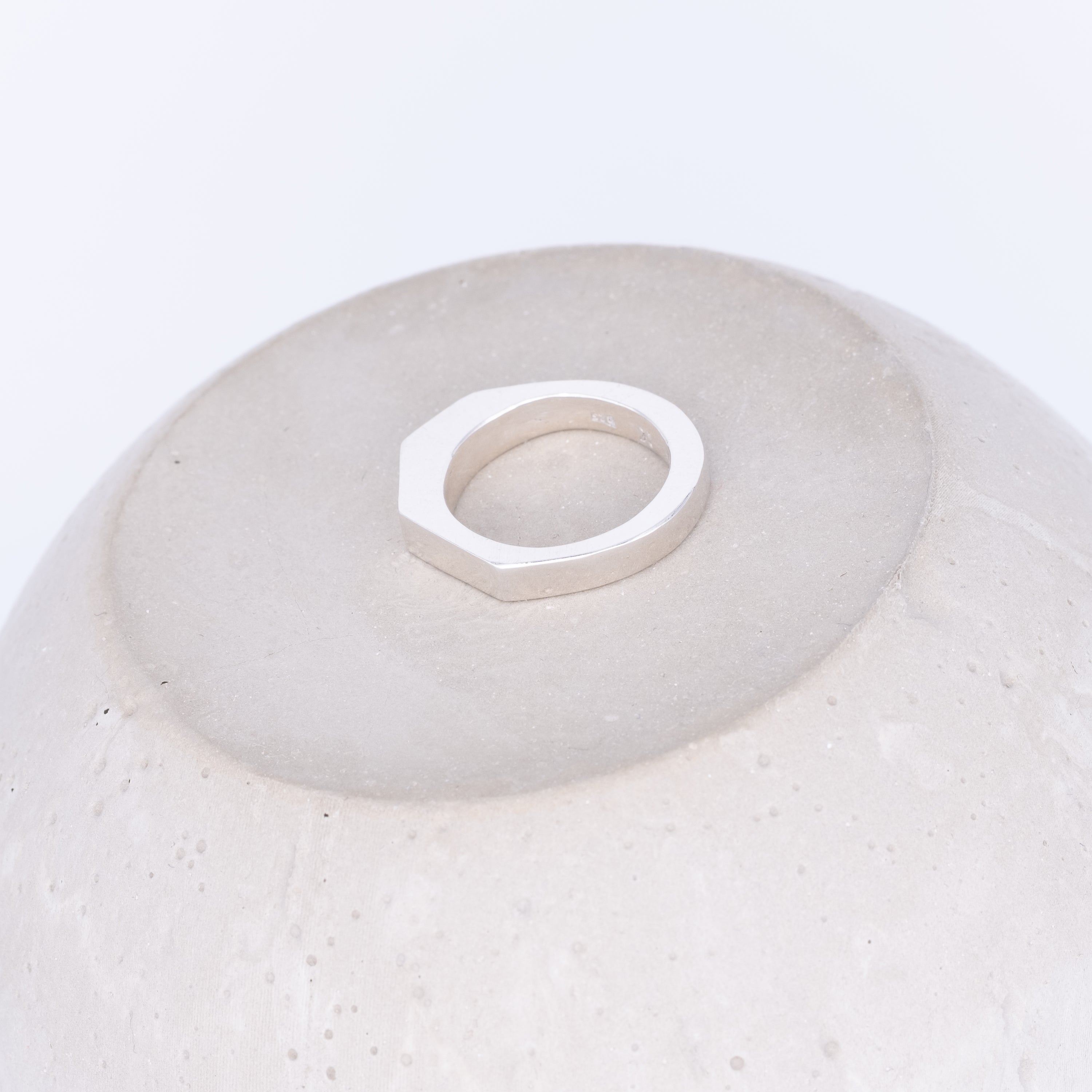 silver ring on a concrete prop