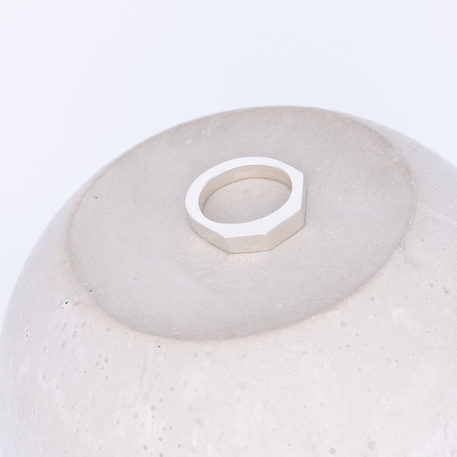 White ceramic bowl with a geometric ring on a white background