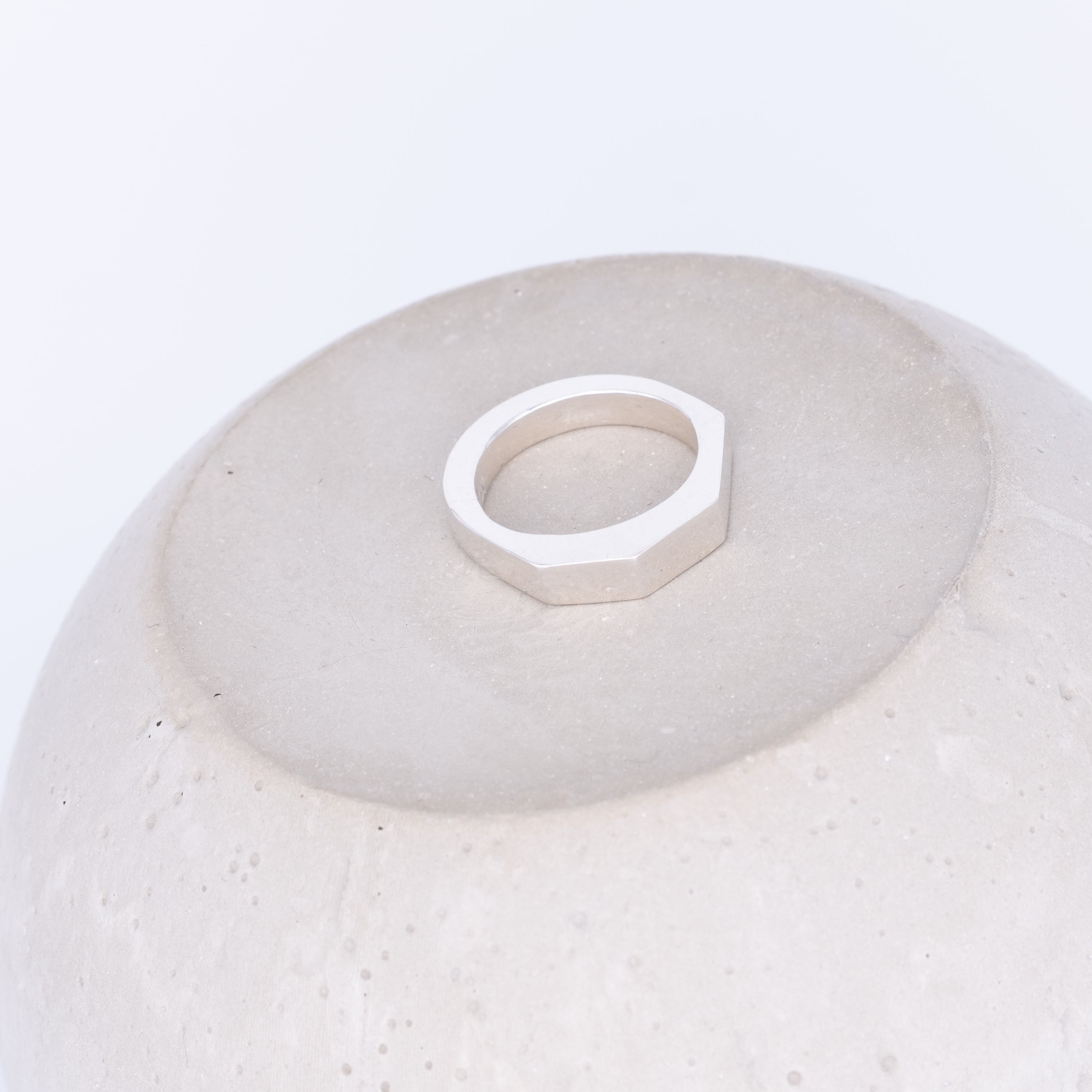 White ceramic bowl with a geometric ring on a white background